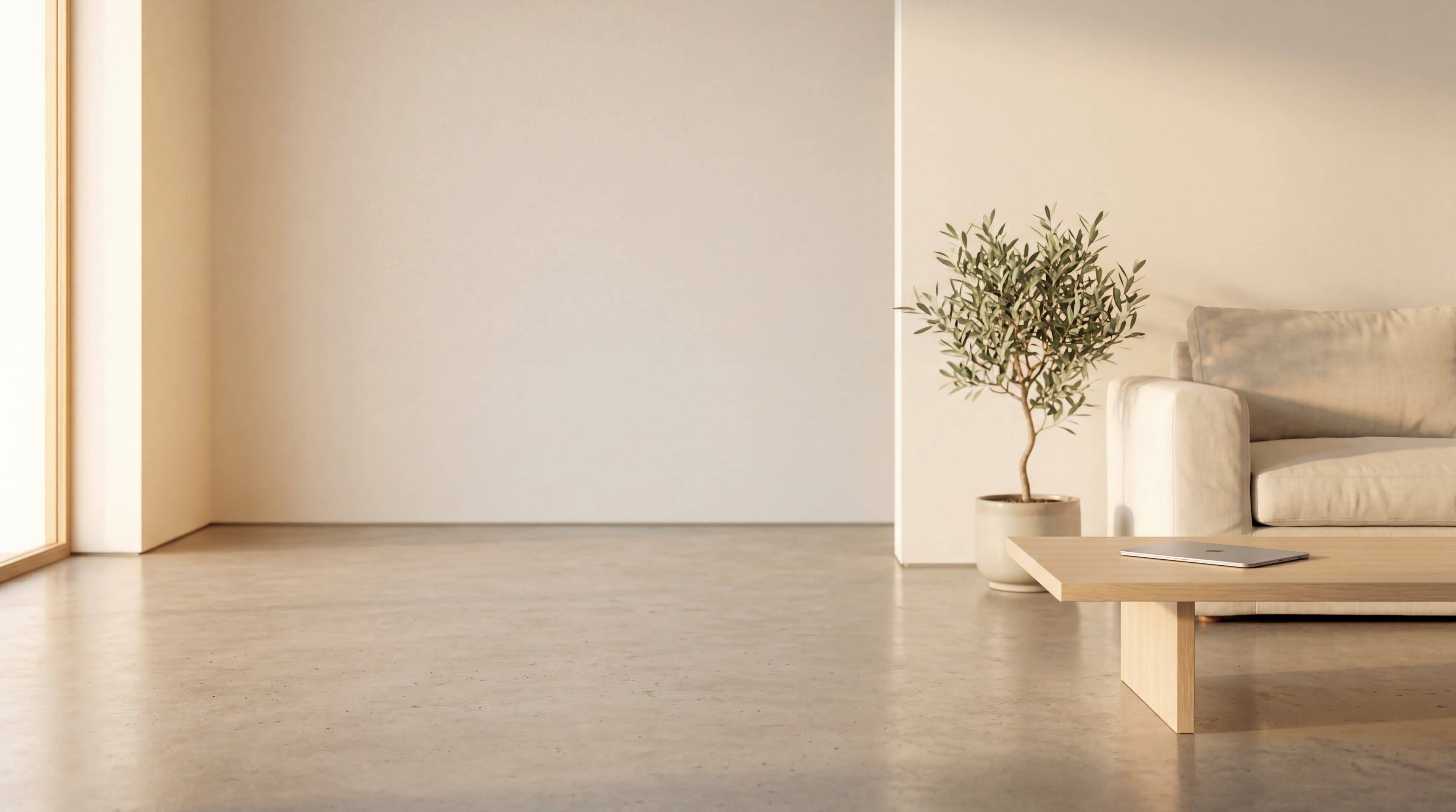 A quiet minimalist family living room with a single tablet on a pale-oak coffee table, soft late-afternoon golden window light.